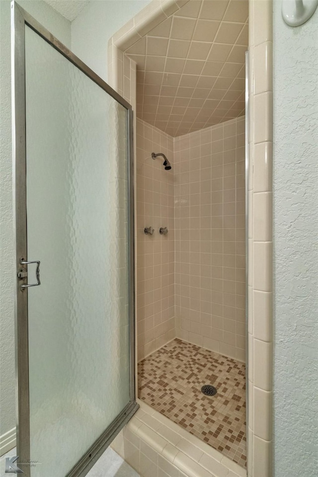 bathroom with a shower with door