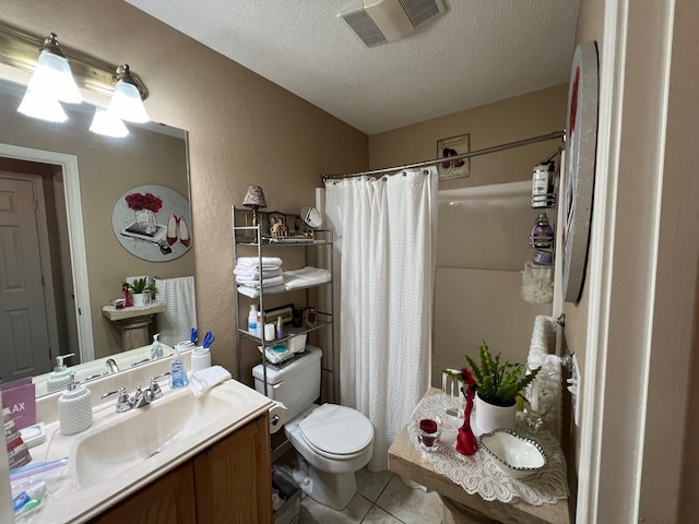 bathroom with a shower with shower curtain, vanity, a textured ceiling, tile patterned floors, and toilet