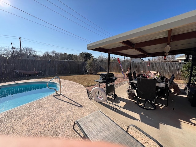 view of pool with area for grilling and a patio area