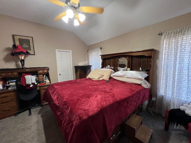 carpeted bedroom with ceiling fan and vaulted ceiling