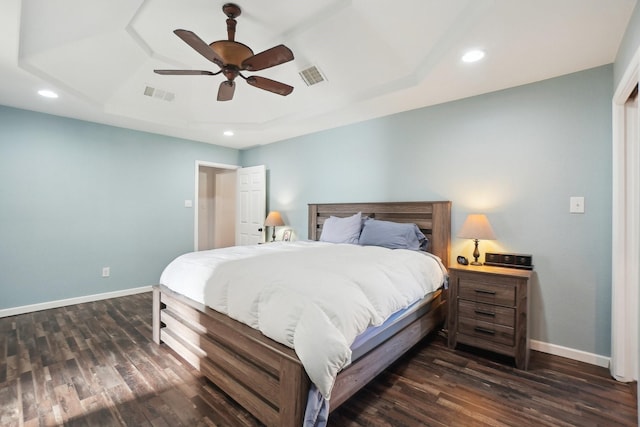 bedroom with a raised ceiling, ceiling fan, and dark hardwood / wood-style flooring