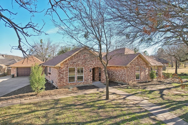 single story home featuring a garage and a front yard