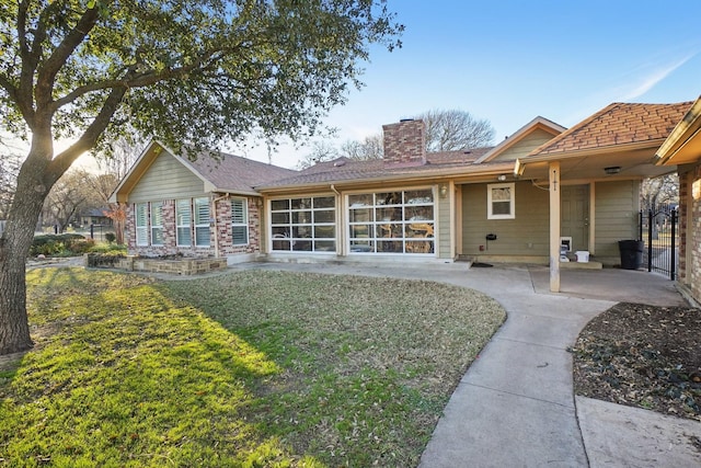 rear view of house with a lawn