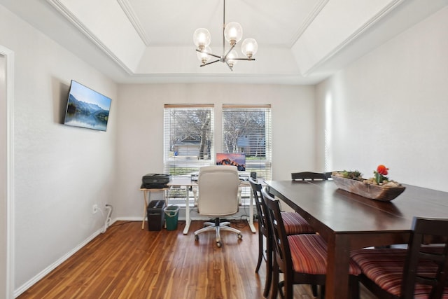 office area with crown molding, a tray ceiling, wood-type flooring, and an inviting chandelier