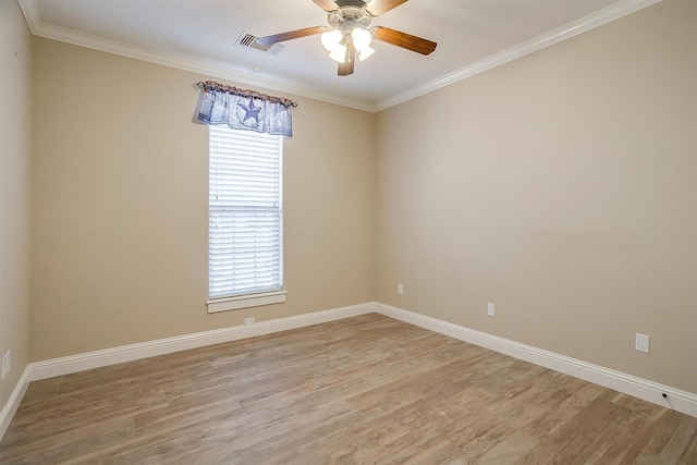 unfurnished room with light hardwood / wood-style flooring, a wealth of natural light, and ornamental molding