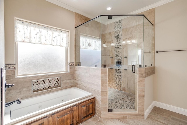 bathroom with crown molding and separate shower and tub