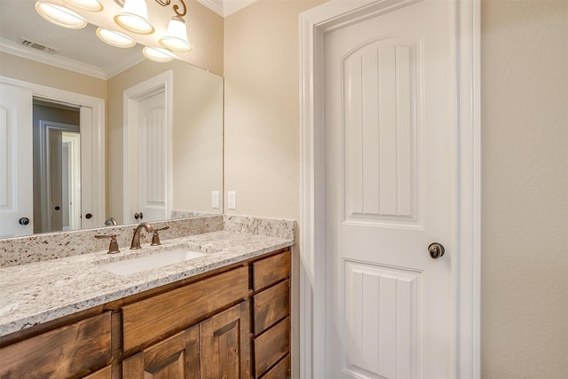 bathroom with vanity and ornamental molding