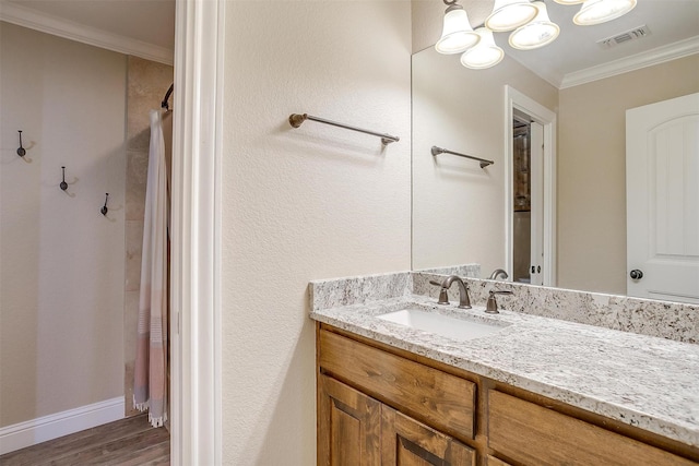 bathroom with a shower with shower curtain, hardwood / wood-style floors, vanity, and ornamental molding