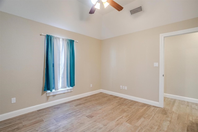 empty room with vaulted ceiling, ceiling fan, and light hardwood / wood-style floors