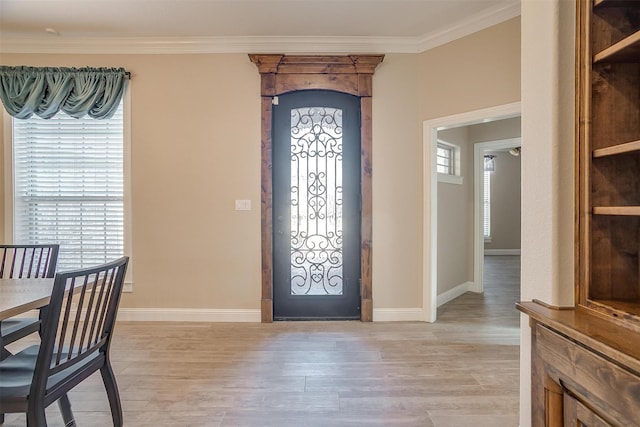 entryway featuring light hardwood / wood-style flooring and ornamental molding