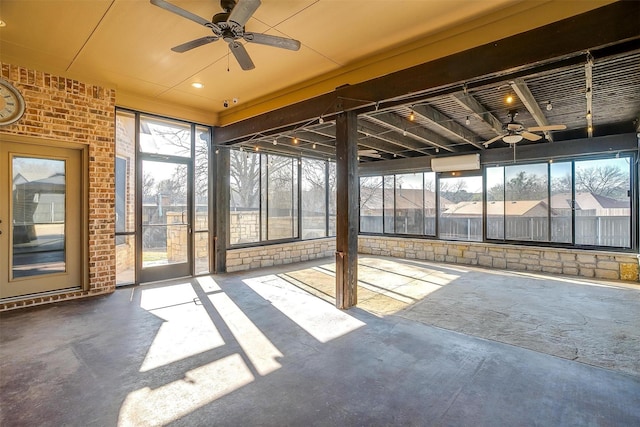 unfurnished sunroom with ceiling fan