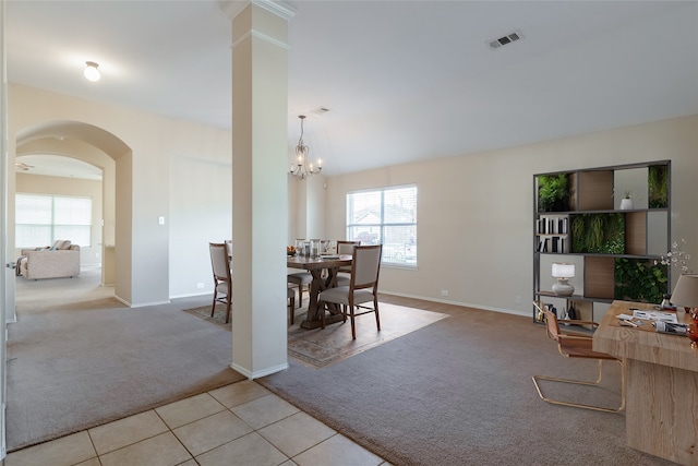 dining room with a notable chandelier and light colored carpet