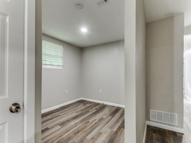 unfurnished room featuring hardwood / wood-style flooring