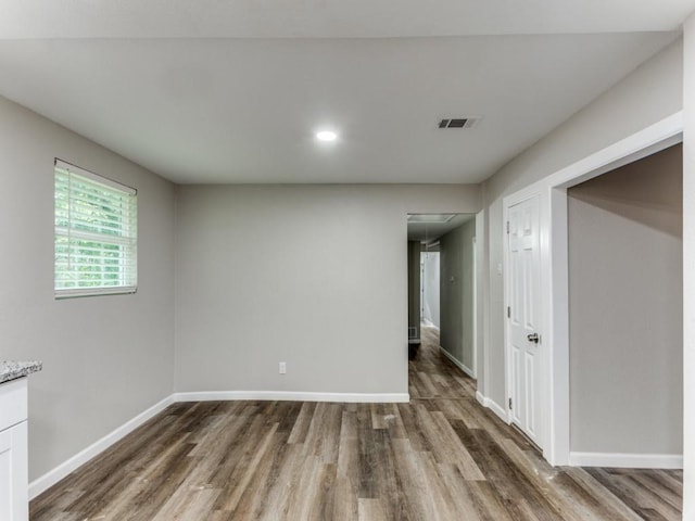 unfurnished room with dark hardwood / wood-style flooring