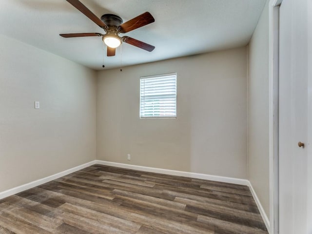 empty room featuring ceiling fan and dark wood-type flooring