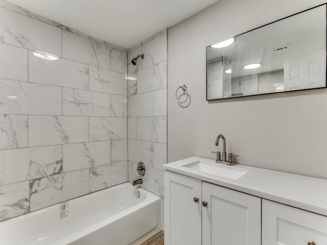 bathroom with vanity and tiled shower / bath