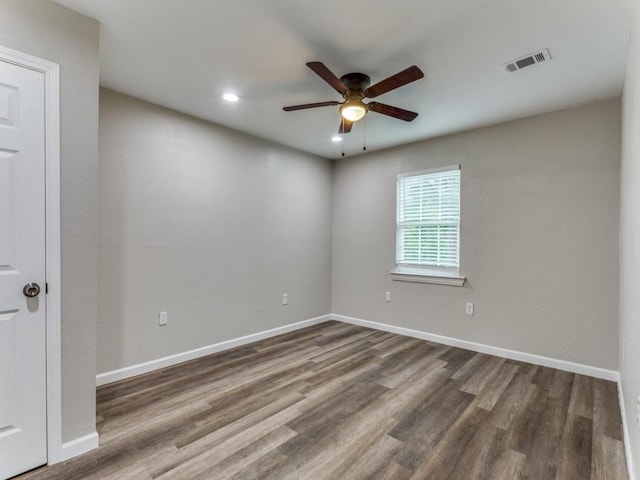 unfurnished room featuring ceiling fan and dark hardwood / wood-style floors