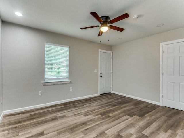 spare room with hardwood / wood-style flooring and ceiling fan