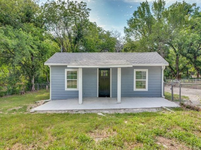 back of house with a lawn