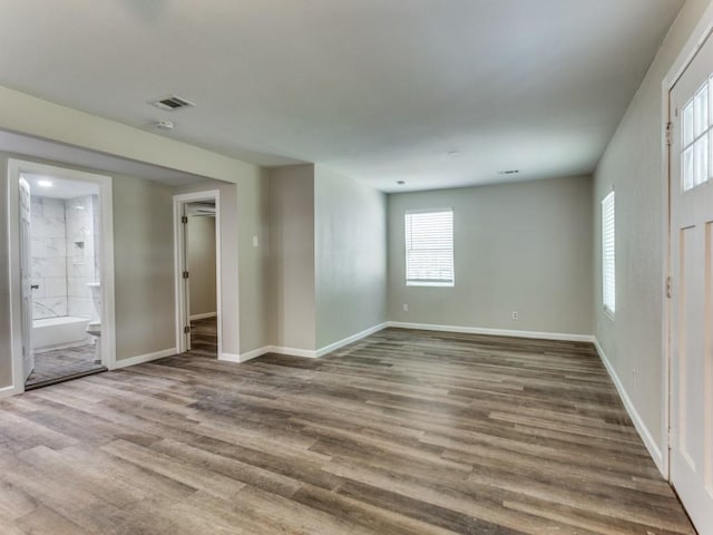 unfurnished room with wood-type flooring