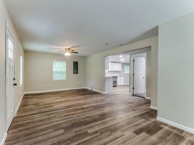 unfurnished living room with electric panel, ceiling fan, and dark hardwood / wood-style floors