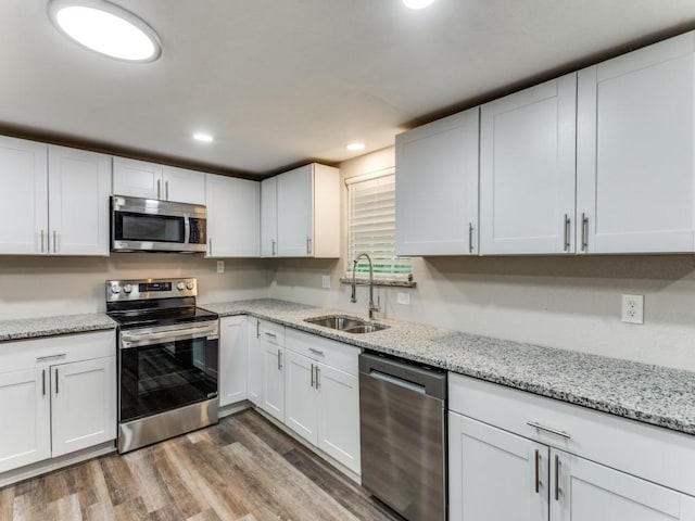 kitchen with white cabinets, dark hardwood / wood-style flooring, stainless steel appliances, and sink