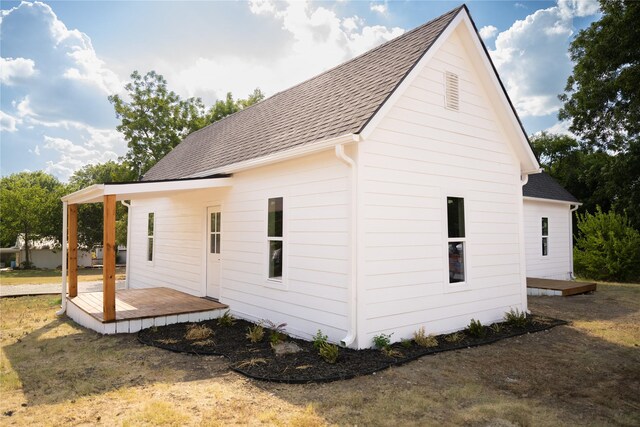 view of home's exterior with a wooden deck