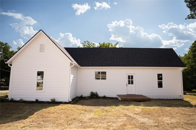 back of property featuring a lawn