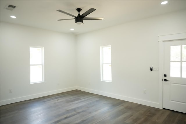 spare room with dark wood-type flooring and ceiling fan