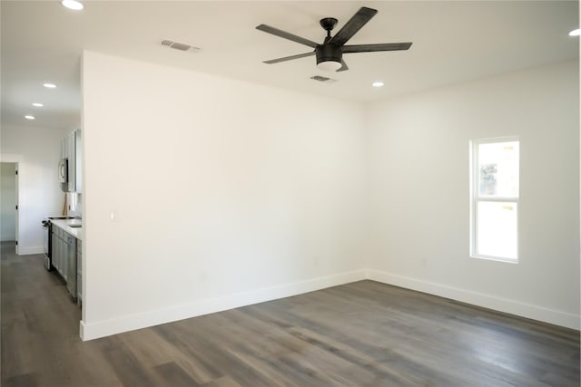 empty room with dark hardwood / wood-style floors and ceiling fan