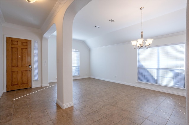 foyer entrance with tile patterned flooring, a chandelier, crown molding, and vaulted ceiling