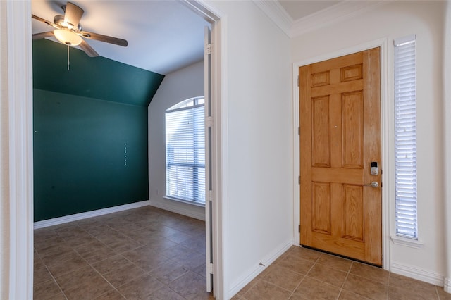 entrance foyer featuring ceiling fan, plenty of natural light, vaulted ceiling, and ornamental molding