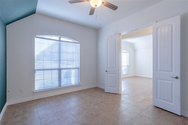 tiled spare room featuring ceiling fan and lofted ceiling