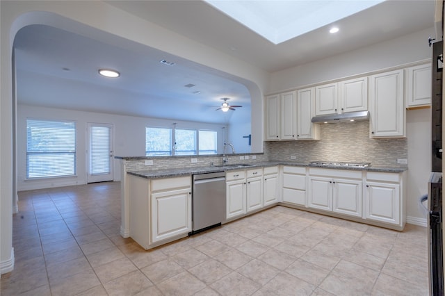 kitchen with kitchen peninsula, appliances with stainless steel finishes, light stone counters, ceiling fan, and white cabinets