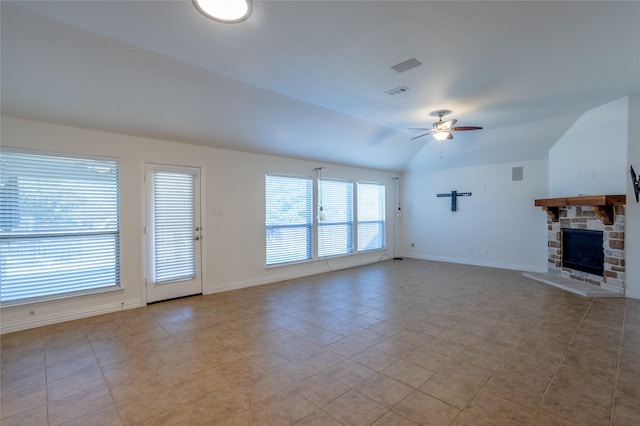 unfurnished living room featuring light tile patterned floors, a stone fireplace, ceiling fan, and lofted ceiling