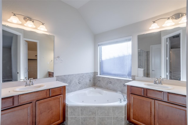 bathroom with vanity, independent shower and bath, and lofted ceiling