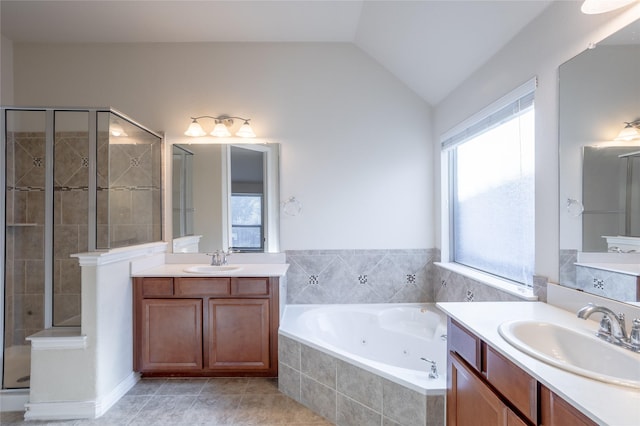 bathroom with plus walk in shower, vanity, vaulted ceiling, and tile patterned flooring