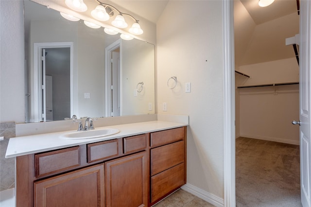 bathroom with vanity and lofted ceiling