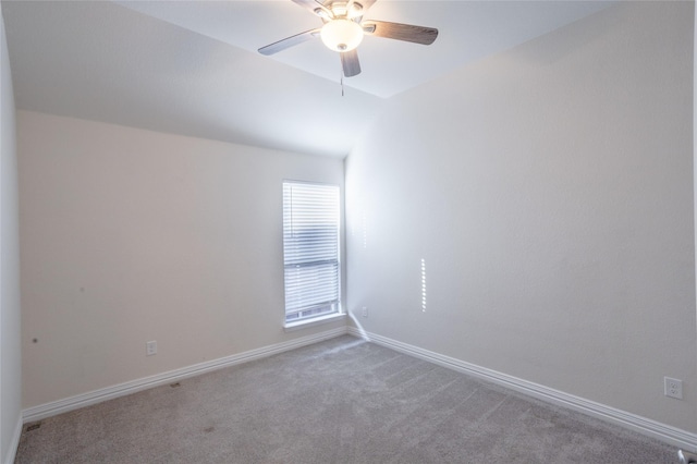 unfurnished room with carpet flooring, ceiling fan, and vaulted ceiling