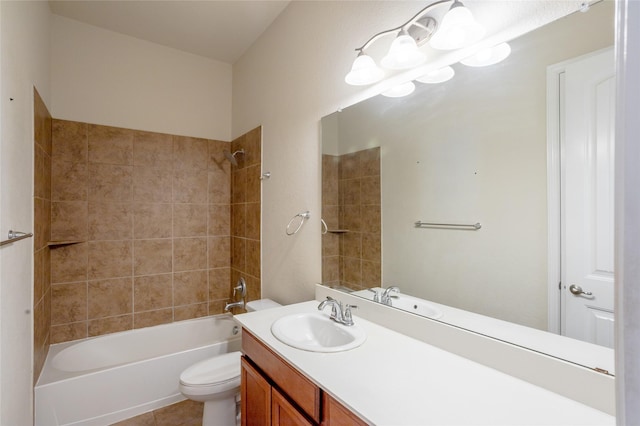 full bathroom featuring tile patterned floors, vanity, tiled shower / bath, and toilet