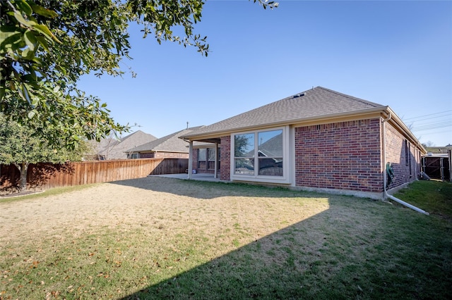 back of house with a yard and a patio area