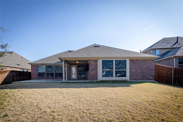 rear view of property with a lawn, a patio area, and ceiling fan