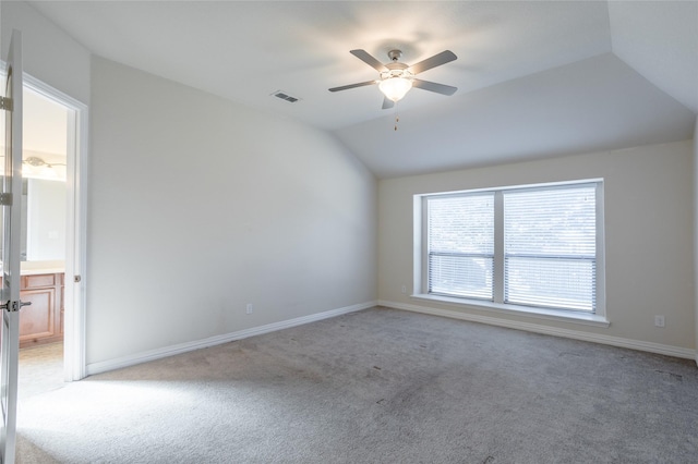 unfurnished room featuring ceiling fan, lofted ceiling, and light carpet