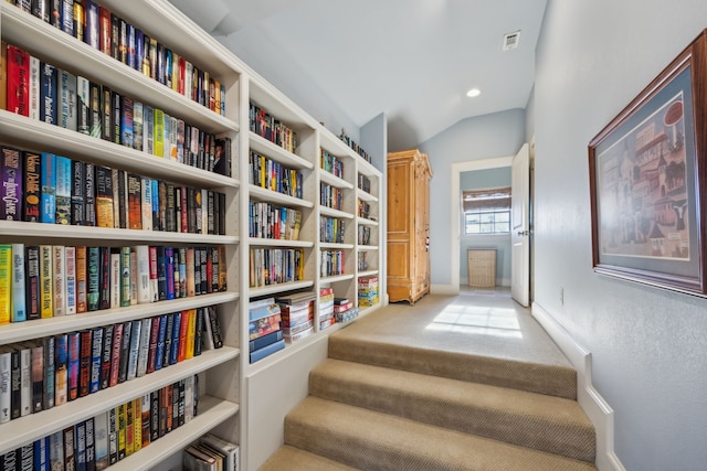 interior space with carpet floors and vaulted ceiling