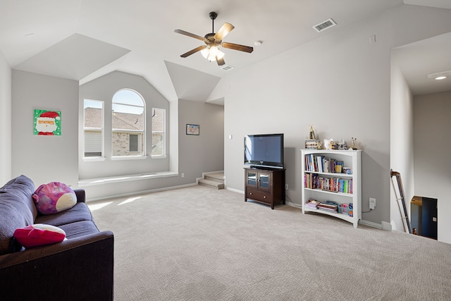 living room with ceiling fan, light carpet, and lofted ceiling