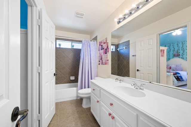 full bathroom with tile patterned flooring, shower / tub combo with curtain, vanity, and toilet