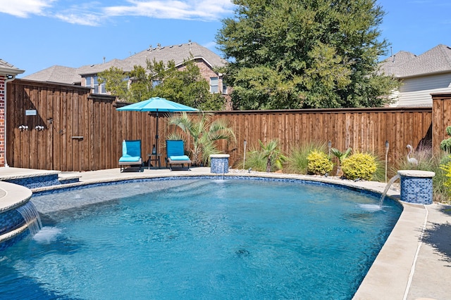 view of swimming pool with pool water feature