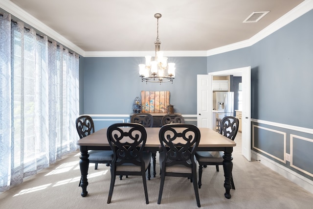 carpeted dining area with a chandelier and crown molding