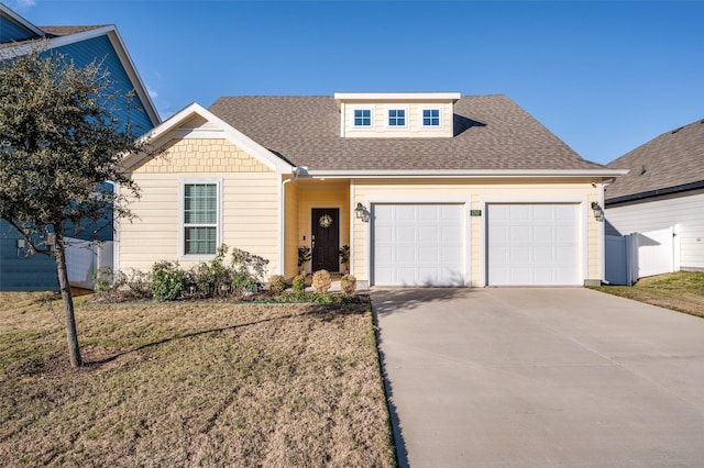 view of front of home featuring a garage and a front yard