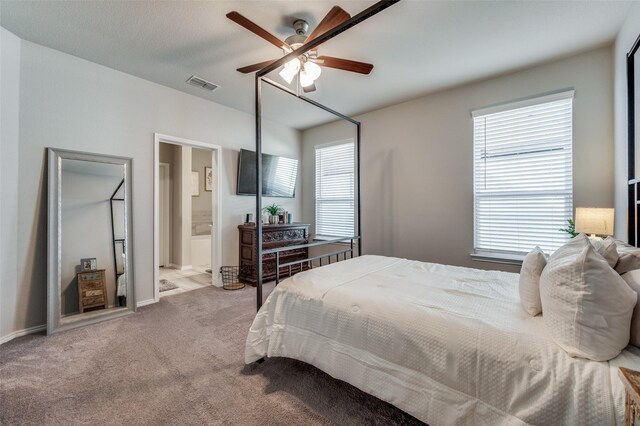 carpeted bedroom with connected bathroom and ceiling fan